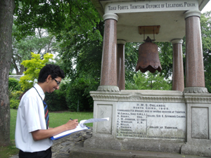 Secondary school pupil studying a war memorial © SLemieux, 2012