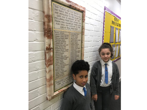 Head boy and girl of St Luke's Primary School with newly installed war memorial plaque c. St Luke's Primary School, 2018