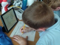 Yr 5 pupil at Meadowbrook Primary School researching the men named on their local war memorial c. War Memorials Trust, 2018