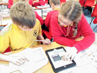 Year 5 and 6 pupils from Cockshutt CofE Primary School researching the fallen named on Cockshutt war memorial © Martin Phillips, 2019