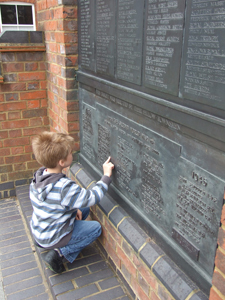 Child looking at a war memorial © J Peach-Miles, 2012