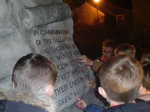 Mytholmroyd Cubs looking at Men of Mytholmroyd District war memorial during night time visit © War Memorials Trust, 2018